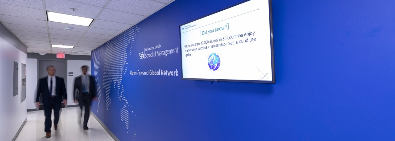 Zoom image: Outside the Office of Alumni Engagement and External Relations, a world map and digital screen featuring alumni spotlights and events will give you a sense of the strength of your alumni-powered global network. 